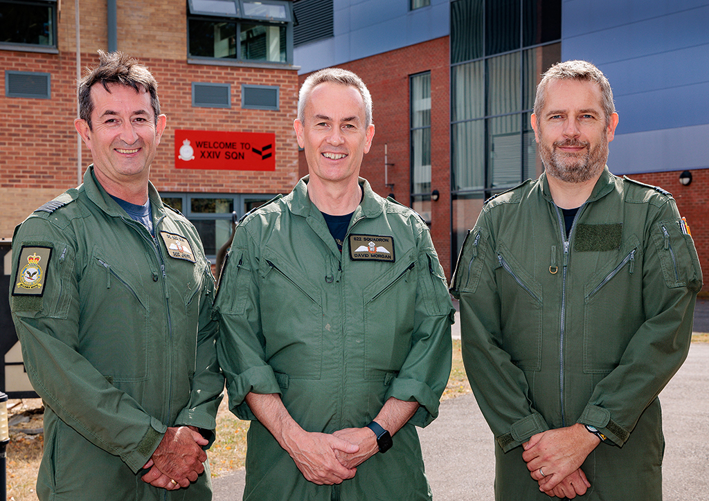 A group photo including Air Commodore Morgan, standing outside the XXIV Squadron building.